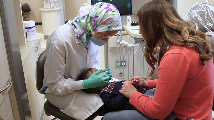 The lap-to-lap technique helps calm a child with dental anxiety